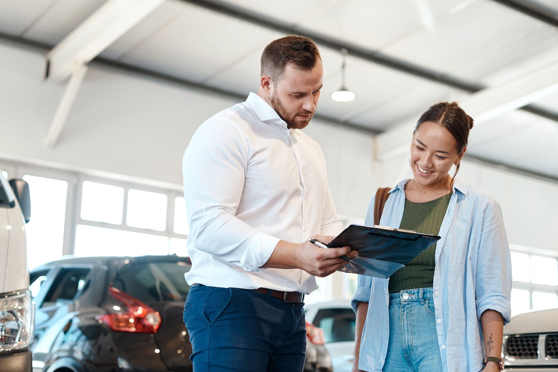 man talking to woman at dealership